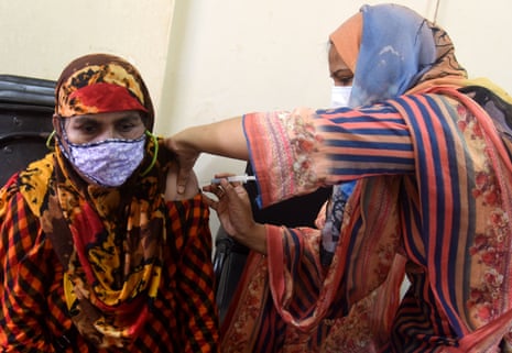 A woman receives a shot of the Moderna jab during a mass vaccination campaign at a vaccination center in Dhaka, Bangladesh.