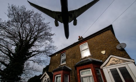 Aircraft come in to land at Heathrow airport over nearby houses.