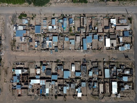 An aerial photograph of neat rows of tin-roofed shacks
