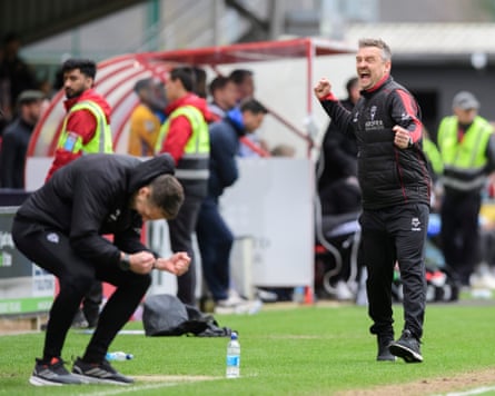 Michael Skubala, head coach of Lincoln City, pumps his fists in celebration after his team beat AFC Wimbledon 1-0 in League One.