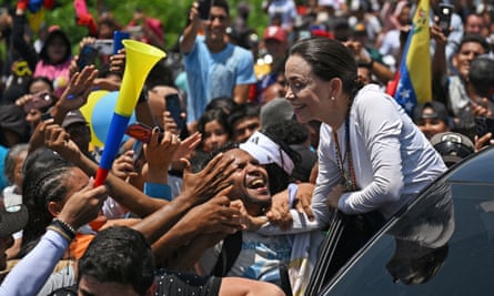 The Venezuelan opposition leader Maria Corina Machado, barred from participating in the election, greets supporters near Sabana de Plata, Zulia state, Venezuela on Tuesday.
