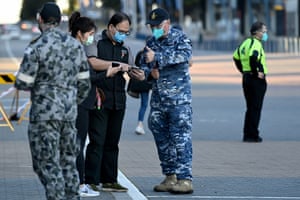 Australian defence force personnel assist people as they check into the Qudos Bank Arena vaccination centre on Monday.