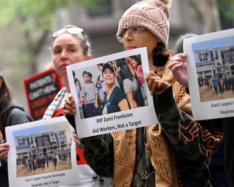 A protester in Melbourne holds a picture of Australian aid worker Zomi Frankcom, who was killed in an Israeli air strike while delivering food in Gaza