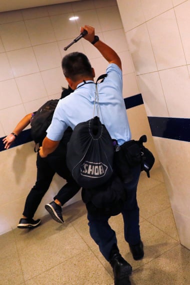 A police officer chases after a flashmob protester inside Hong Kong International Airport, Hong Kong, China September 1, 2019.