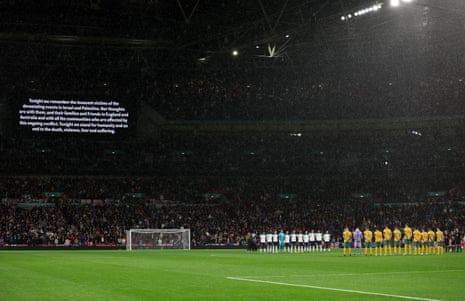 Players, fans and match officials observe a minutes silence
