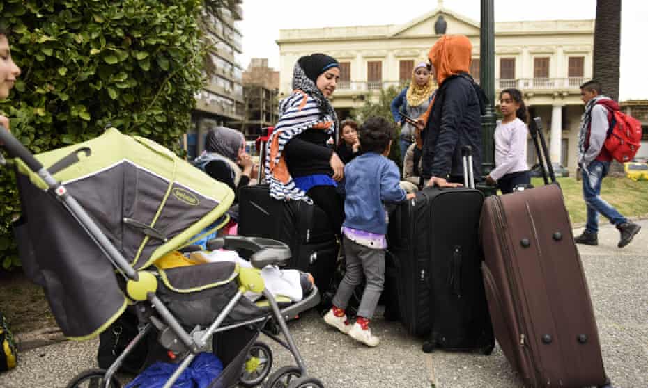 A group of Syrian refugees gather with their belongings in Independence Square in Montevideo, Uruguay, on Monday. The refugees who were welcomed to Uruguay last year are staging a protest demanding authorities allow them leave the South American country.