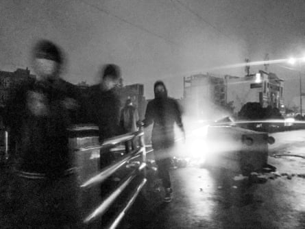 Protesters block a street and set fire to bins