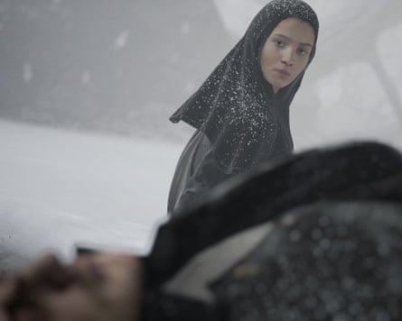 Screengrab from the game Indika in which a woman looks over a man lying down