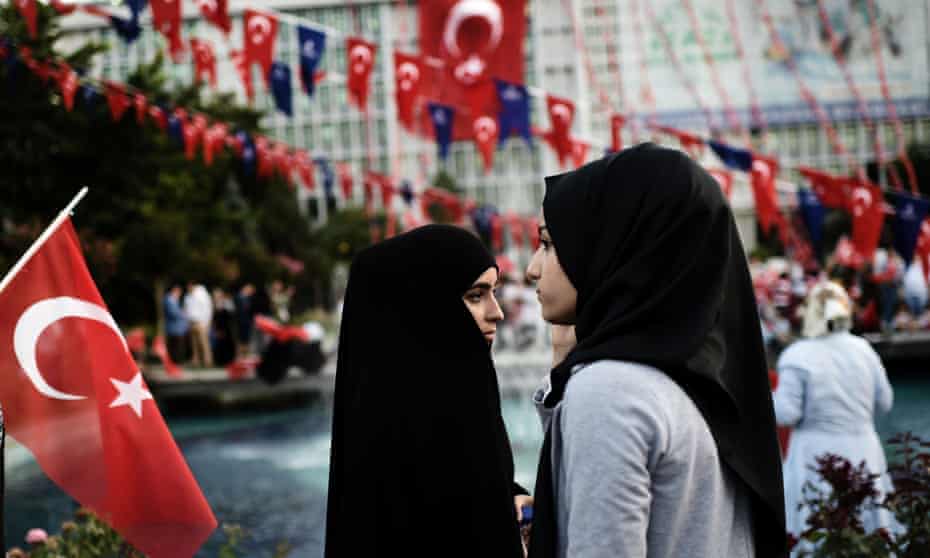 Women wearing headscarves attend a pro-government demonstration last July outside city hall in Istanbul