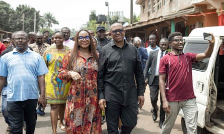 Peter Obi (centre) walking with his wife, Margaret Brownson Obi, after casting their ballots