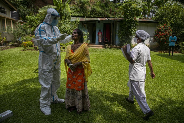 A health worker takes a nasal swab sample to test for Covid-19 during a door to door test drive in Gauhati, India, on Saturday, 29 August, 2020. India has the third-highest coronavirus caseload after the United States and Brazil, and the fourth-highest death toll in the world.