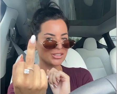 a woman showing her middle finger with a ring on it