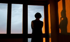A woman looking out of her window.