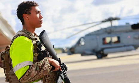 A soldier guards a helicopter in Rønne, Denmark, after the discovery of a fourth gas leak on the Nord Stream pipelines damaged earlier this week in the Baltic Sea.