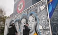 Workmen create an art installation celebrating women's football  at Brentford FC's stadium.