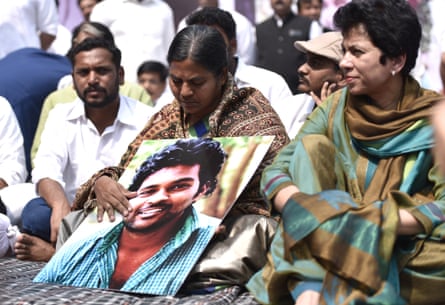 The mother of Dalit PhD student Rohith Vemula cradles a photograph of her son.