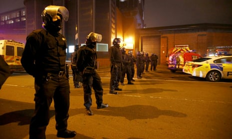 Police officers in riot gear stand outside Winson Green prison