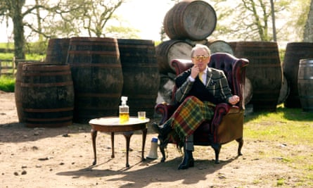 Cumming with tartan jacket and blanket on set.