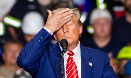 a man holds his hand to his forehead