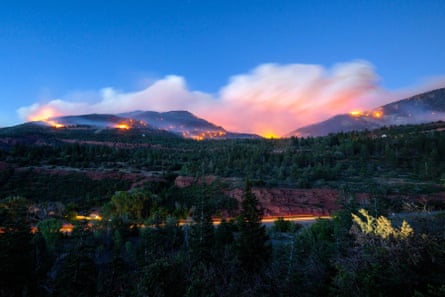 smoke from a fire behind a mountain