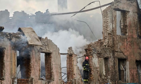 A firefighter examines a destroyed medical facility building in Dnipro, central Ukraine, after a Russian missile attack that left two people dead