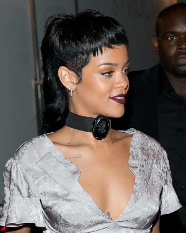 Rihanna in a sliver dress wiht her pair pulled back into a structured mullet style at the back