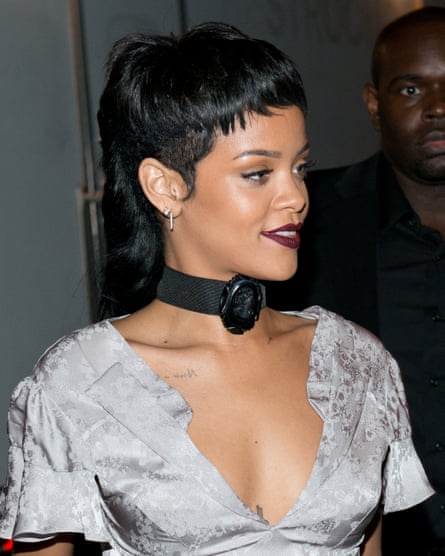 Rihanna in a sliver dress wiht her pair pulled back into a structured mullet style at the back