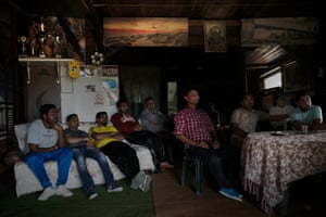 A group of Sikhs unwind by watching an Indian cricket match on TV.