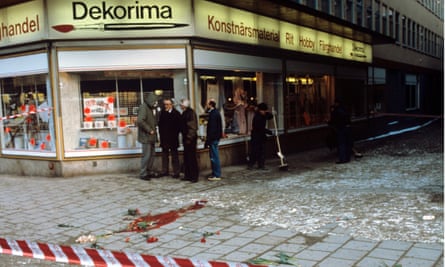 Stockholm street corner, 1986, a large bloodstain is visible on the ground behind police tape