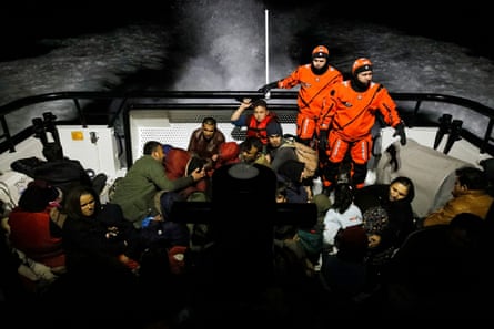 Migrants board a Turkish coastguard boat