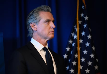 Man stands next to flag