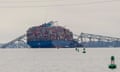 A container ship rests against wreckage of the Francis Scott Key Bridge on Wednesday, 27 March 2024.