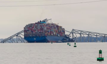 A container ship rests against wreckage of the Francis Scott Key Bridge on Wednesday, 27 March 2024.