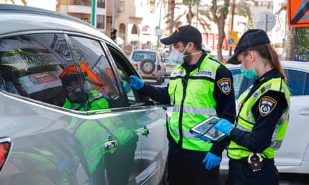 Israeli police stop a vehicle at a checkpoint in Bnei Brak, a city east of Tel Aviv