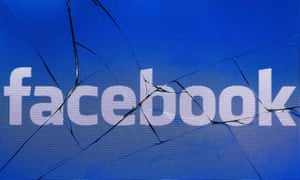 Facebook logo on a cracked phone screen