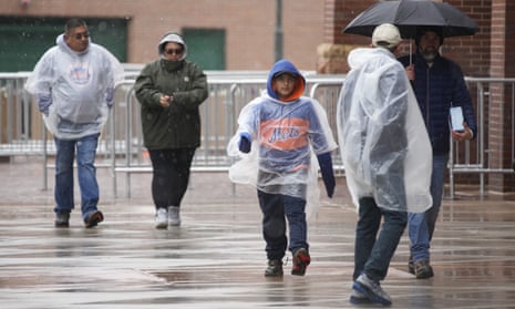 Baseball fans outside Coors Field in Denver, Colorado, after the cold front forced the postponement of a baseball game between the New York Mets and the Colorado Rockies