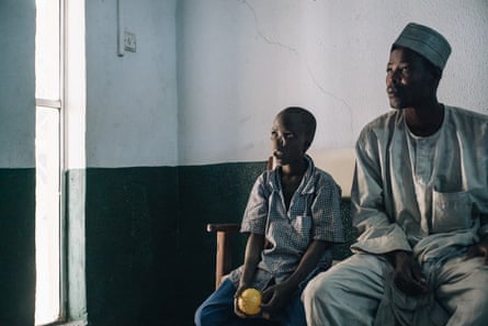 Adamu, a 14-year-old noma survivor from Kebbi state, waits with his father Nadiri to be examined by surgeons at the Noma Hospital in 2017.