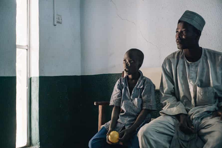 Adamu, a 14-year-old noma subsister  from Kebbi state, waits with his begetter  Nadiri to beryllium  examined by surgeons astatine  the Noma Hospital successful  2017.