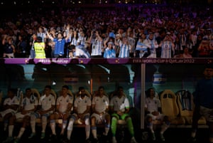 Argentina fans sing behind the dugout as the teams come out for their semi-final against Croatia at Lusail Stadium.
