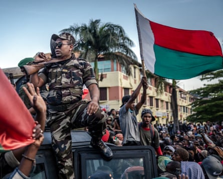 Madagascar flag waved by protesters and army personnel on top of vehicle