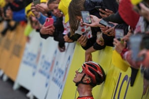 Fans take pictures of Thymen Arensman after he crossed the finish line to win the nineteenth stage of the Tour de France.