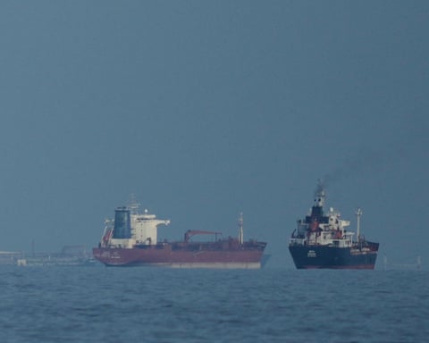 Oil tankers and cargo ships line up in the Strait of Hormuz.