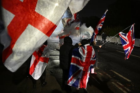 People protest in the dark with flags