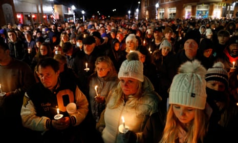 People gather for a candlelight vigil for the victims of the Oxford High School shooting in downtown in Oxford, Michigan on December 3, 2021.
