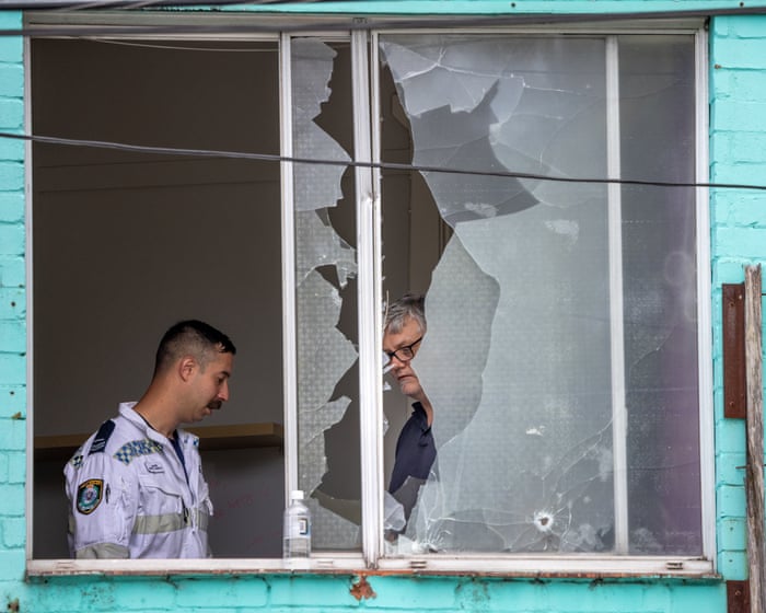 Man arrested after at least 50 shots fired from Sydney flat injure bystanders and hit buildings and cars