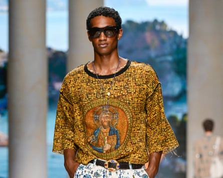 A model in a top featuring a religious icon