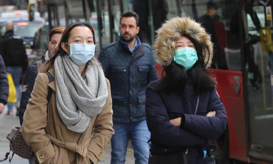 People in London wearing medical masks