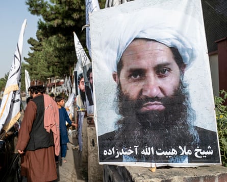 A poster on a street of a man wearing a turban with a long beard