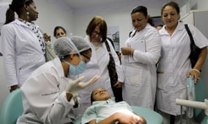 Cuban doctors observe a dental procedure during a a training session at a health clinic in Brasilia, Brazil. 4896.jpg?width=300&quality=85&auto=forma