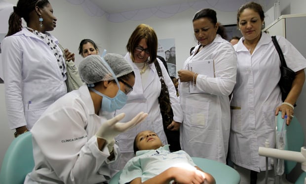Cuban doctors observe a dental procedure during a training session at a health clinic in Brasilia, Brazil.